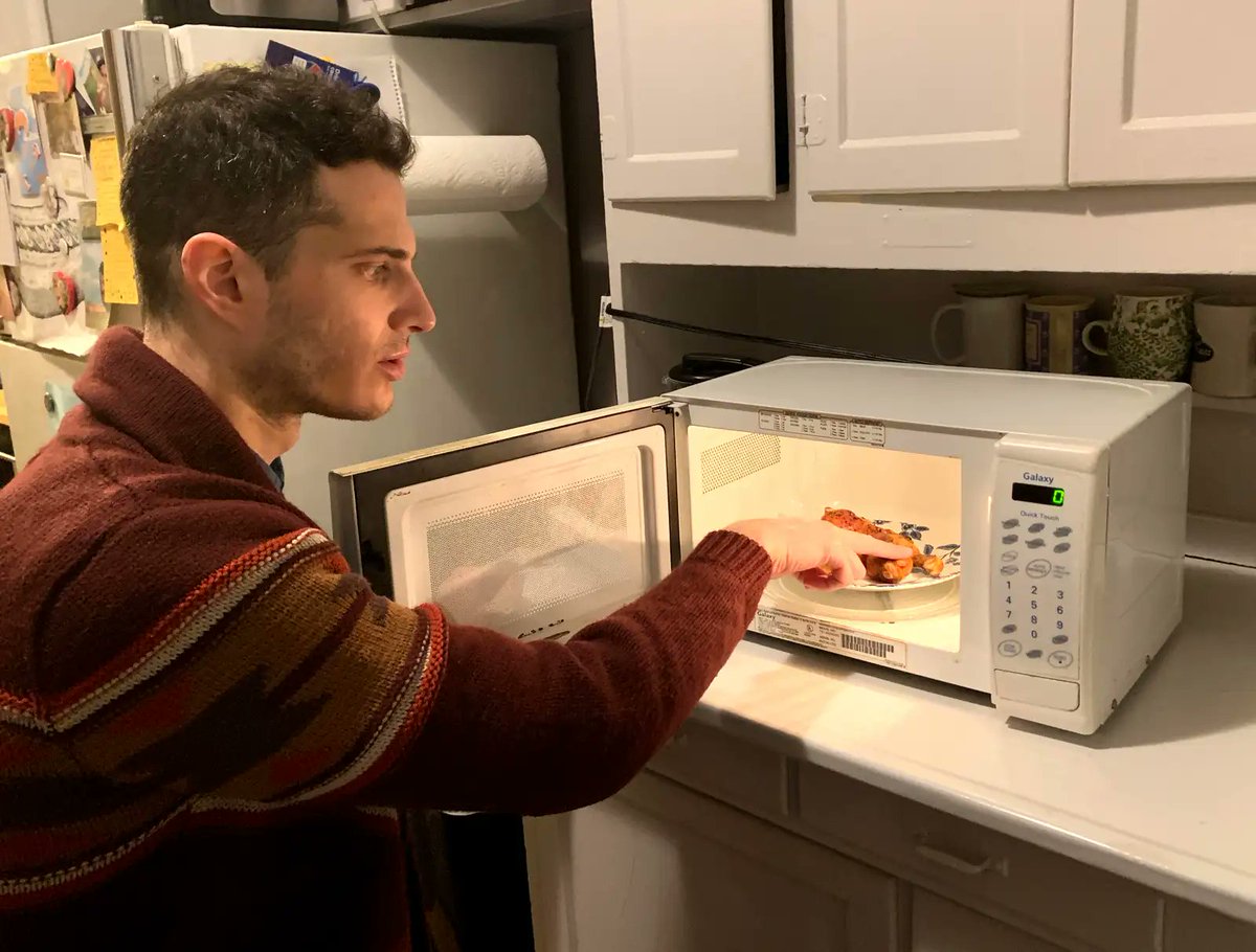 TheOnion's tweet photo. Man Checking If Chicken Wings Got Hot Enough In Microwave Like First Responder Searching For Pulse https://t.co/q19E6JYBiv https://t.co/RPzK0amKw5