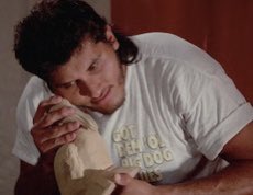 I watched another bad episode of Baywatch with <a href="/MorganPThrapp/">His Girl Fieri</a> &amp; <a href="/Snotsnit/">Snotsnit World Tour</a> for <a href="/RookieSchoolPod/">Baywatch Rookie School</a>, which at least gave us the gift of the screen shot below, &amp; the discovery that it’s impossible to do any serious acting in a Big Dog shirt. God bless you for trying, Giant Gonzalez.