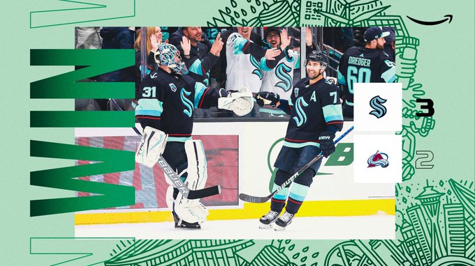 Final score win graphic with a green gradient background. Win is written in green letters along the left side. An image of Grubauer fist-bumping Eberle is overlayed in the center of the graphic. The score is 3-2 in favor of the Kraken and an amazon logo is in the upper right corner. 