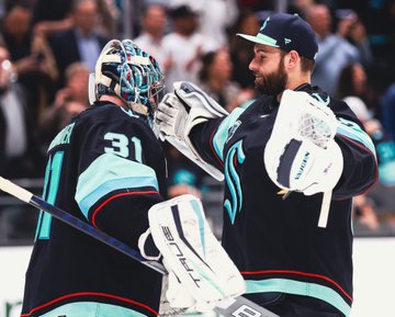 Chris Driedger prepares to give Philipp Grubauer a hug following the team’s 3-2 win over Colorado