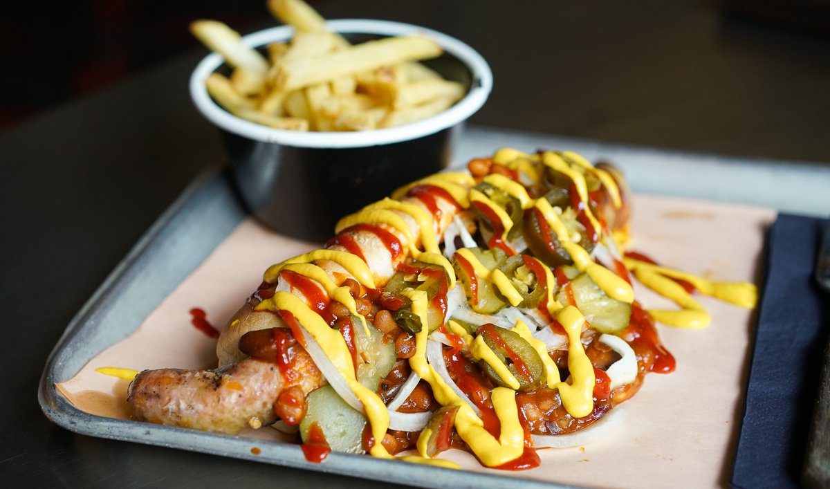 RedsTrueBBQ's tweet photo. Introducing: the Pit Dog 🌭 

Smoked whole Cheese &amp; Jalapeño sausage, covered in Pit Beans, onions, jalapeños, yellow mustard, ketchup, pickles and served in a lightly grilled hoagie 🔥 

#PitDog #HotDog #MessyEating https://t.co/z0WcQvzFb1