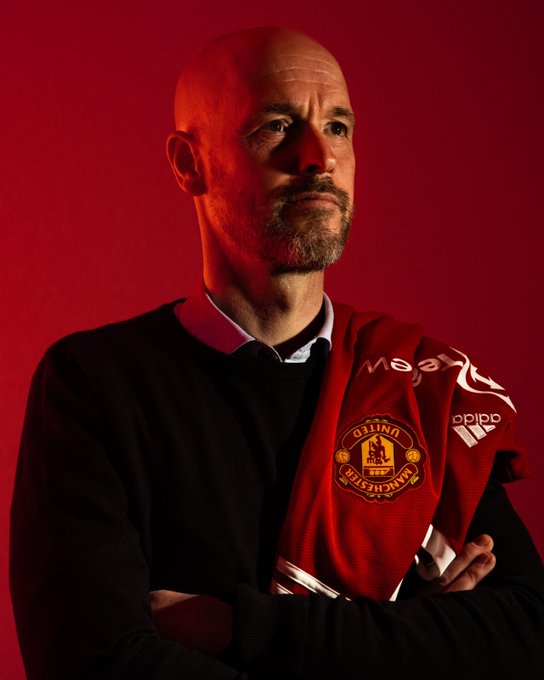 Erik ten Hag poses with a Manchester United shirt.