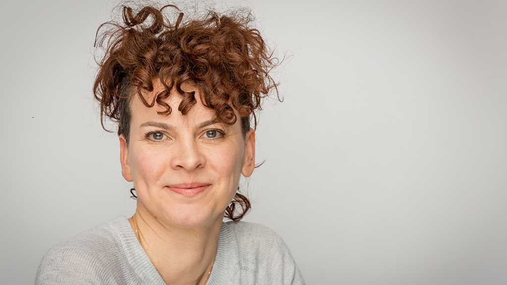 Julia McKenzie wears a grey jumper and smiles
