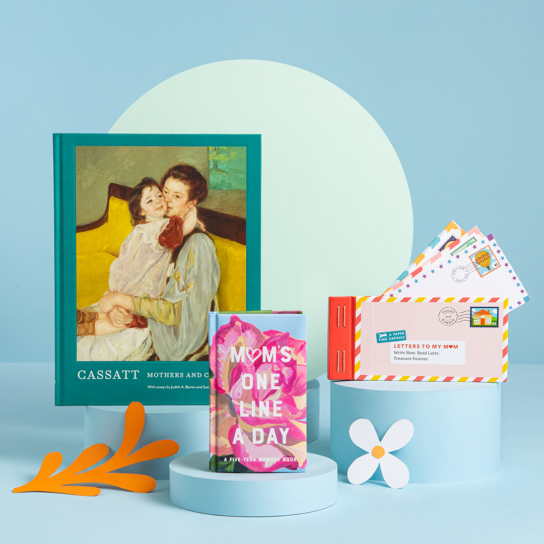 A blue background with books propped up around paper cut-outs of flowers, half circles, and circles. 