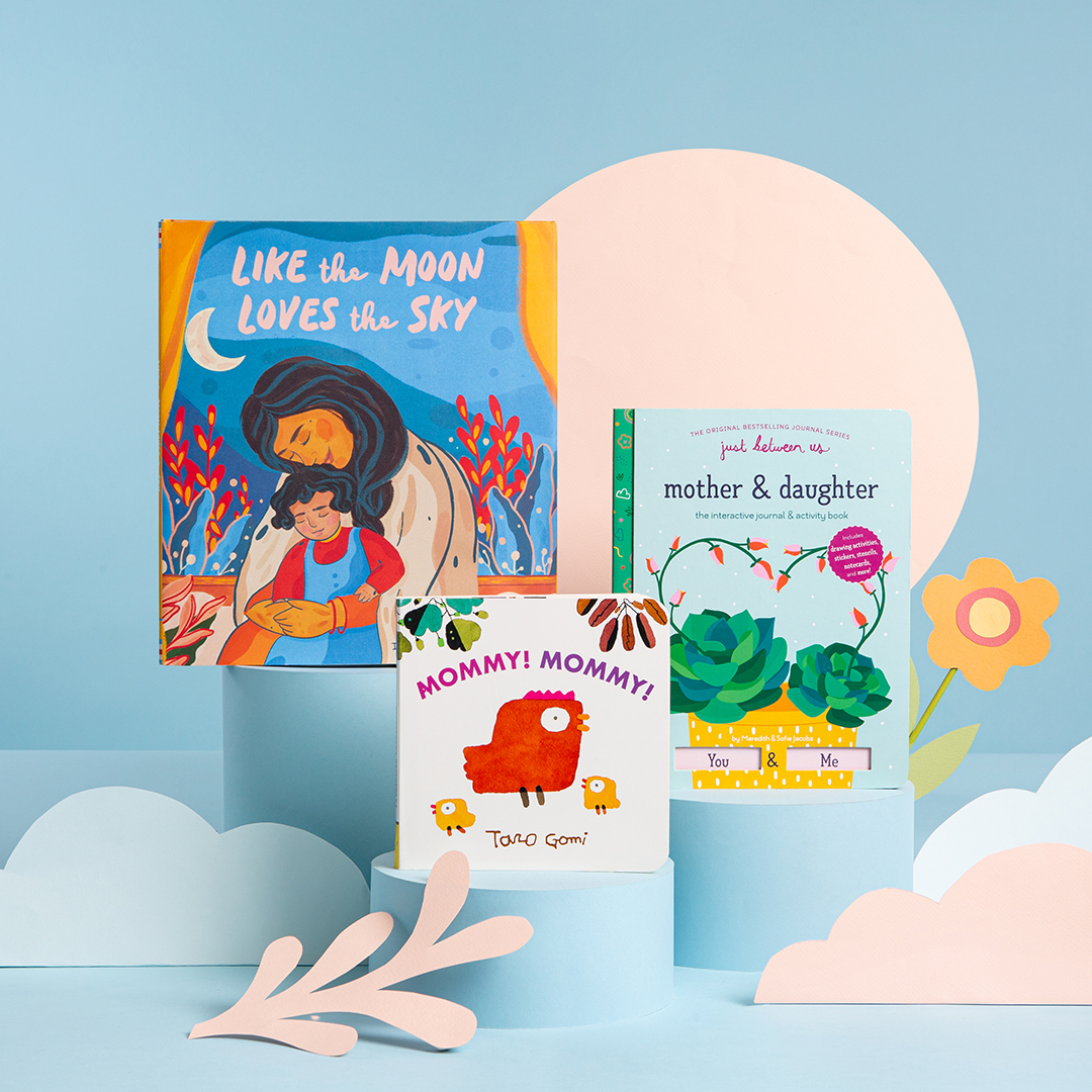 A blue background with books propped up around paper cut-outs of flowers, half circles, and circles. 