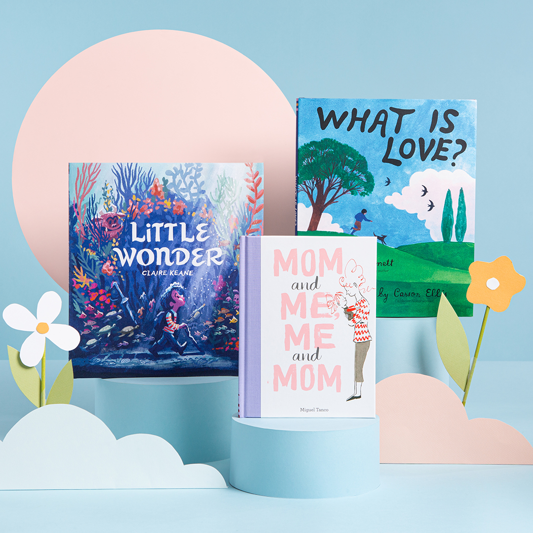 A blue background with books propped up around paper cut-outs of flowers, half circles, and circles. 