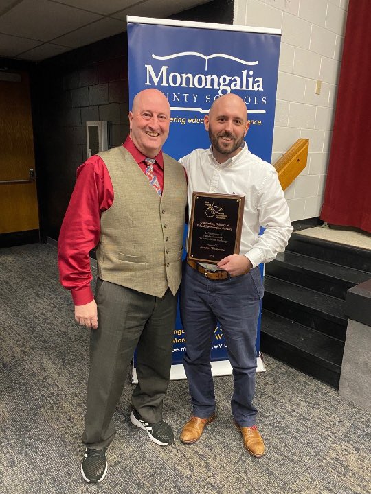 Dr. Campbell congratulates school psychologist, Andrew Woolwine, on his award for innovative practices in school psychology.