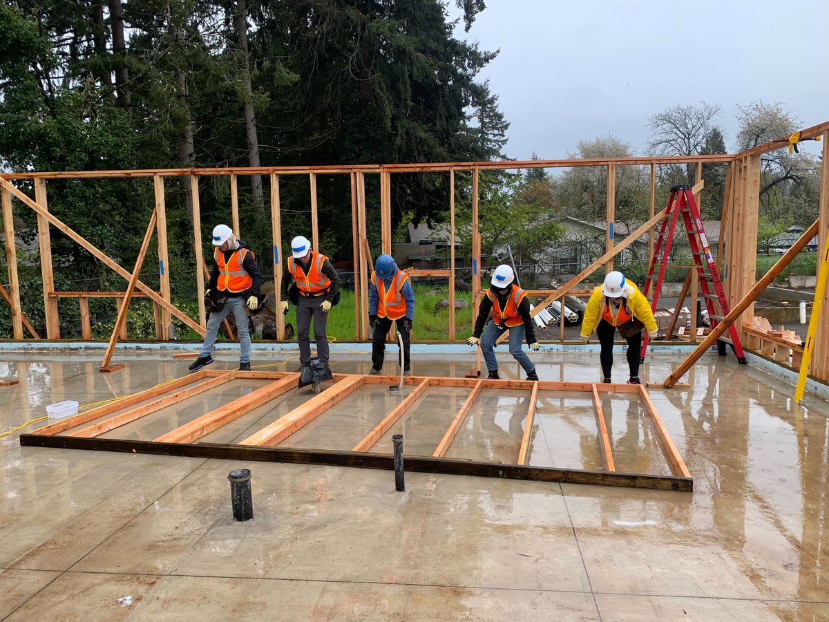 vacasarentals's tweet photo. Yesterday, our #Portland #Vacasa team had a great time volunteering (rain or shine!) with @habitatportland to frame houses for a 40-unit development in the Lents Neighborhood. https://t.co/FIjEJczxlA