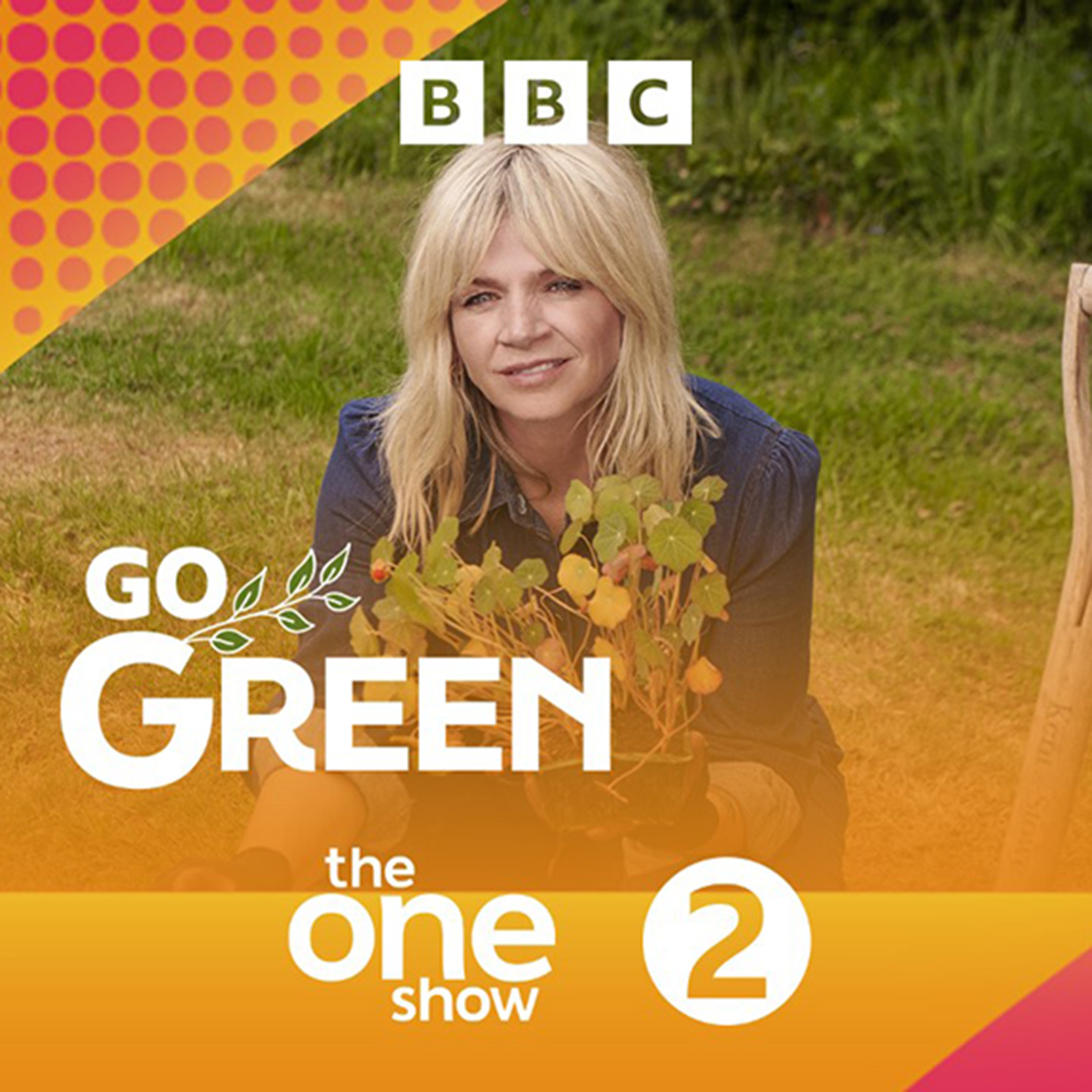 Zoe Ball holds a plant, ready for planting in the ground. Go Green is written in white, along with the logos for The One Show and BBC Radio 2.