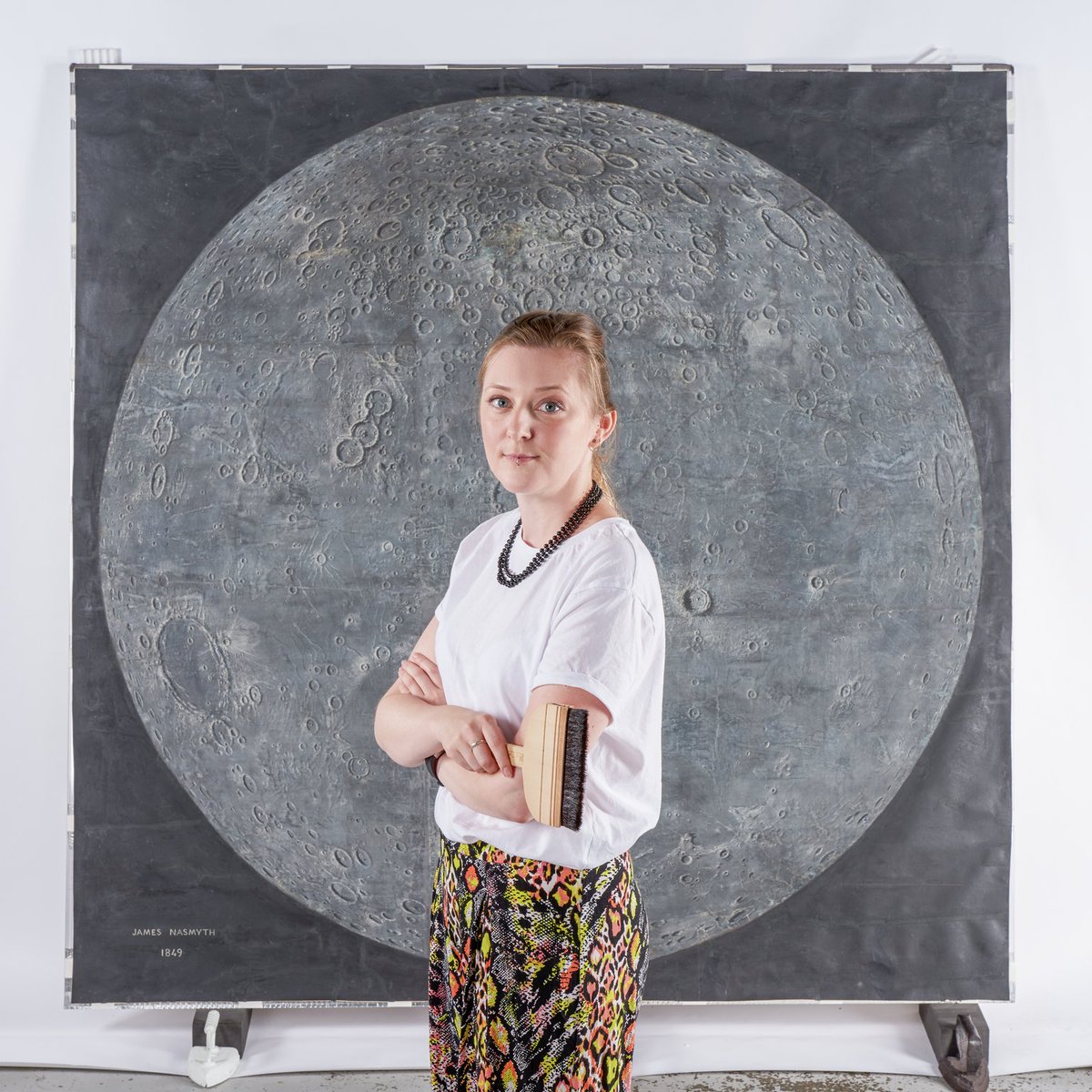 Crannster's tweet photo. To pay homage to that #Whereyoustarted photo & to Stephen Allen & my traineeship, I got the brush out again 2019 for this photo. Smug pose after I had spent a glorious 6 months conserving this beautiful painting of the moon by James Nasmyth #paperconservation #stillaposer https://t.co/orN5F4w0Sg