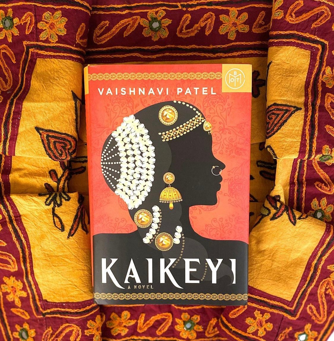 A copy of the book KAIKEYI on top of a brocade pillow.