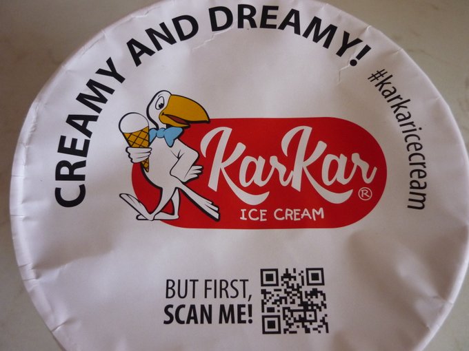 Underneath the lid: in the middle there's the funny logo with a cartoonish bird holding an ice cream cone, having above the 'creamy and dreamy! #karkaricecream' text on a half circle and below a prompt 'but first, scan me!' next to a QR code.