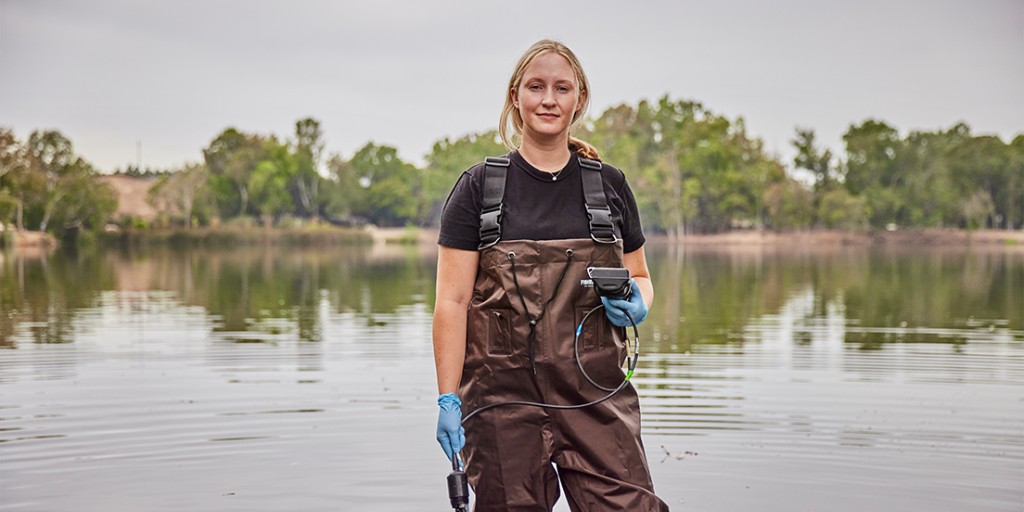 Algae biologist Jayme Smith, PhD in a small body of water, measuring for algae populations with the Southern California Coastal Water Research Project (SCCWRP). 