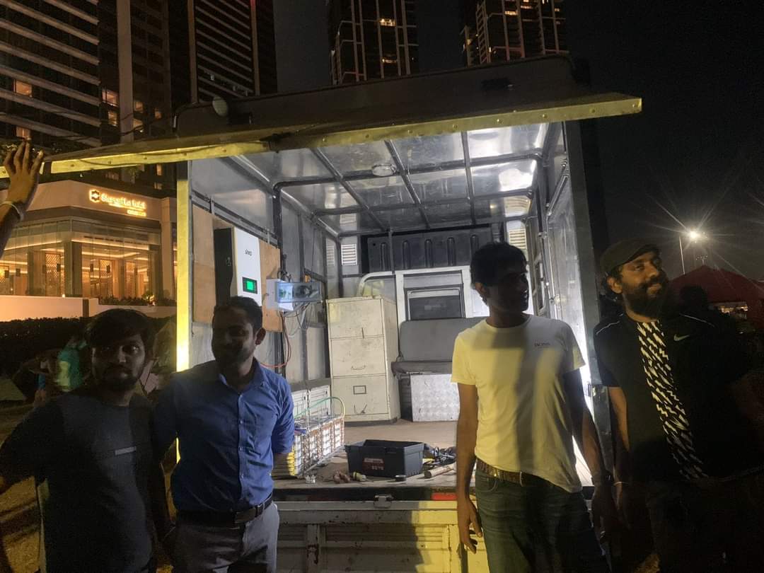 Welikumbura's tweet photo. This is our solar power plant/truck &amp; the crew that provides power to part of the tents in #GotaGoGama.

#lka #SriLanka #GoHomeGota #GotaGoHome #GoHomeRajapakshas #පන්නමු https://t.co/0ts84yoVX4