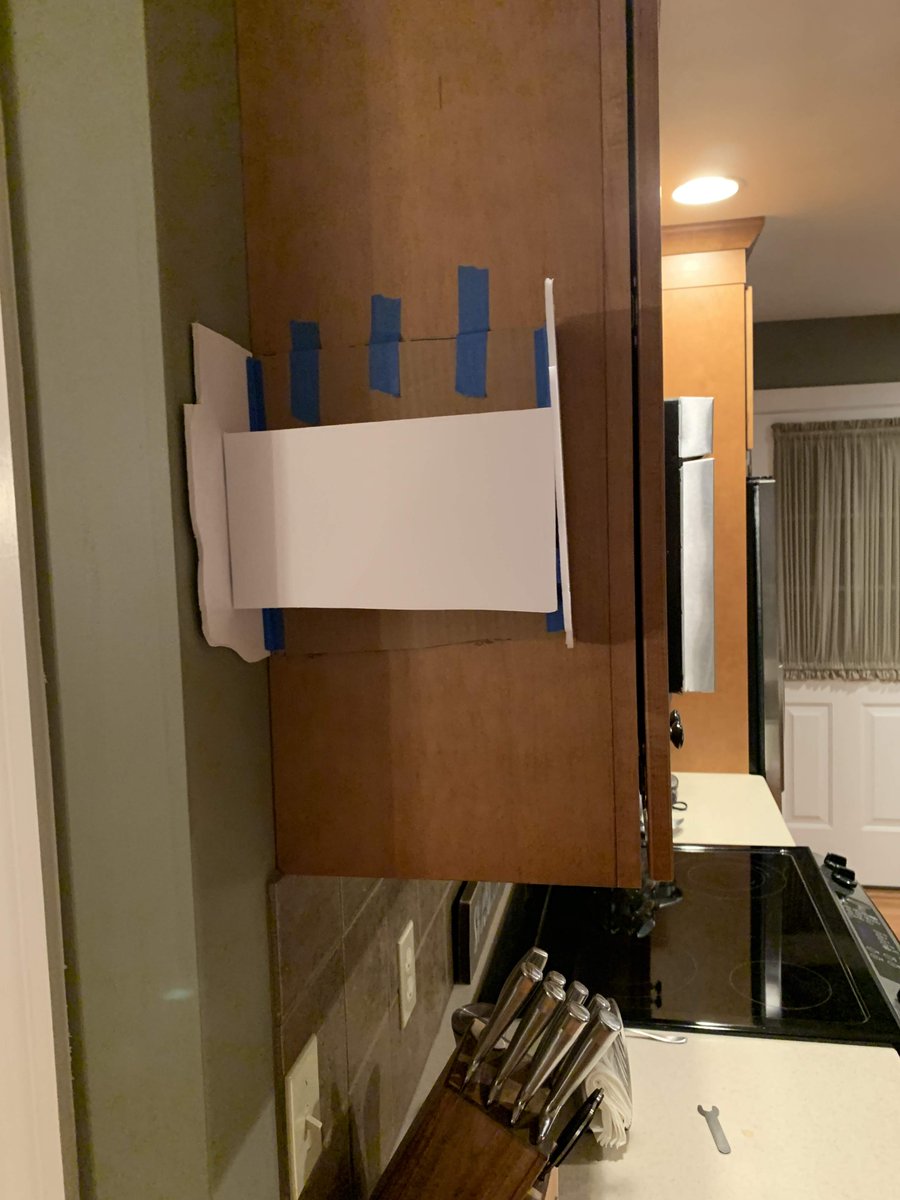 Originally, I thought that perhaps the edge of a kitchen / mail organizer could define a side of the head (roughed-out here in foam core), and a shadow cut across the wall in background might help complete it.