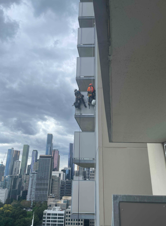 CladdingSafeVic's tweet photo. This (brave) crew are using swing stages and abseils to rectify longer vertical runs of combustible cladding at this Melbourne building. #cladding #claddingsafety https://t.co/HcQOVH6xvf