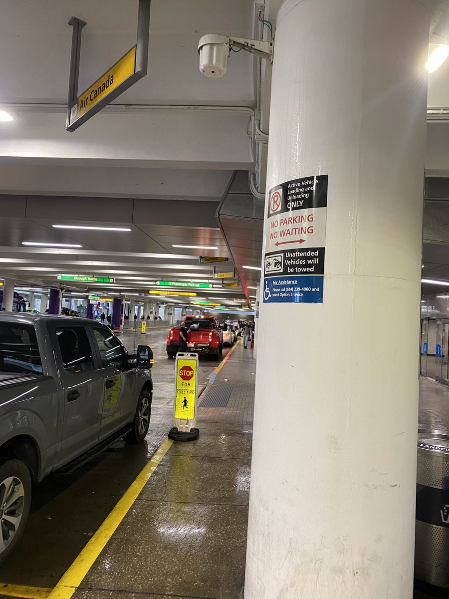 nathan_internet's tweet photo. @columbusairport Here’s a photo of 12 cars parked and waiting next to signs that say No Parking, No Waiting. The “security” staff walking past chatting with each other wasting your payroll resources. It’s been like this for ~2 months now and I am triggered. https://t.co/plW3CWe3Wa