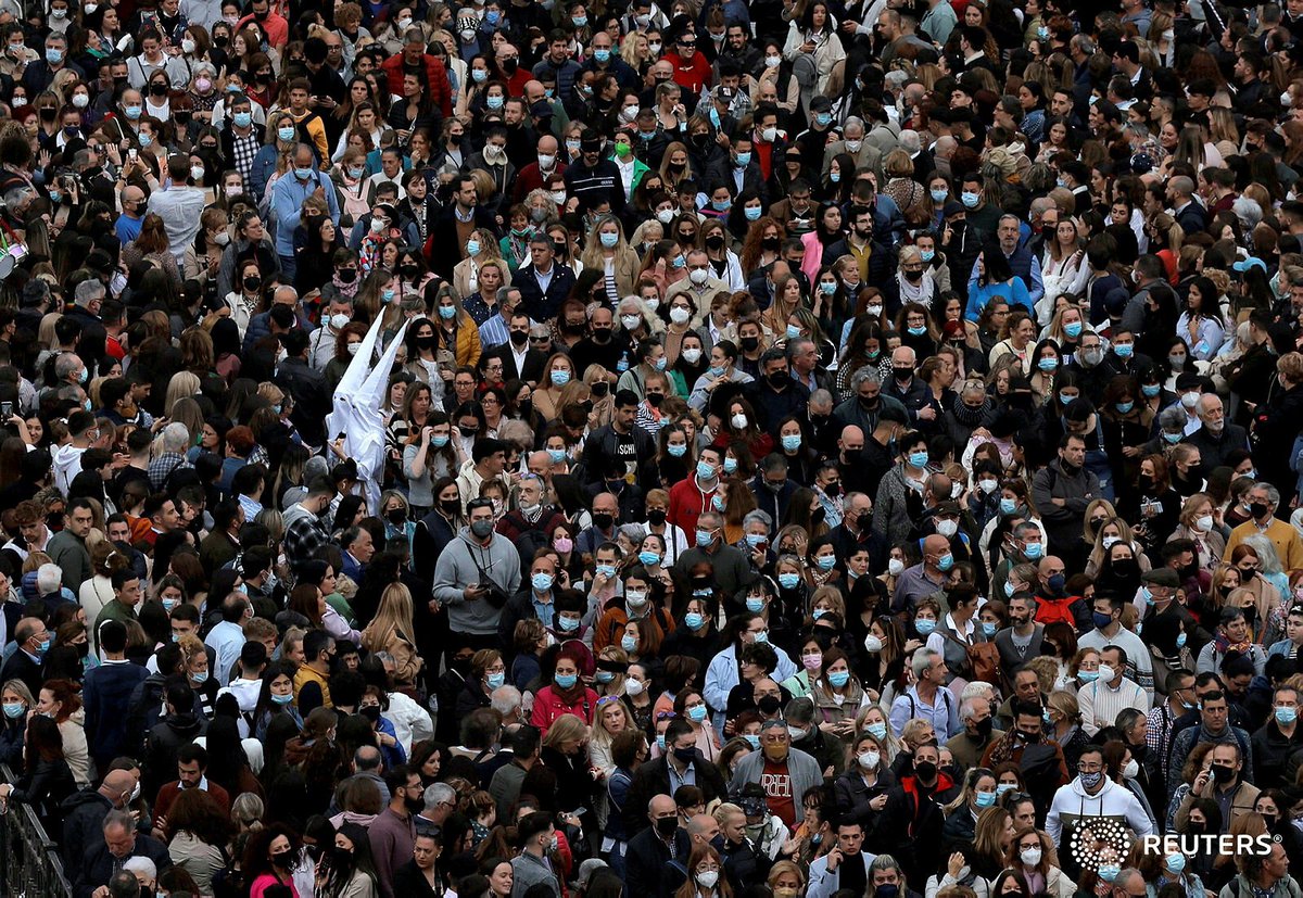 JonNazca's tweet photo. Two penitents walk between the faithful of Cautivo brotherhood, as they take part in a procession, after processions were cancelled for the last two years due to the COVID-19 pandemic, in #Malaga, Spain, April 11, 2022. REUTERS/Jon Nazca #HolyWeek #SemanaSanta2022 https://t.co/poeULA49nN