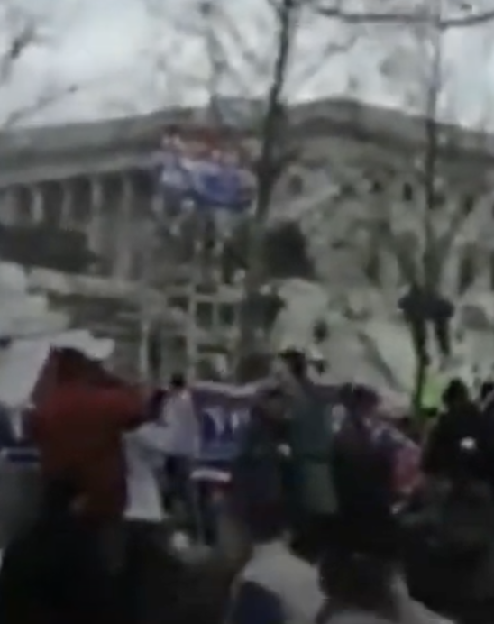 capitolresearc3's tweet photo. @OSINTyeti @CMominator It's after 2:03 PM because the #BigMediaTowerFlag is up. #ShadowFlynn was on the center W. lawn at 1:59 PM pacing & talking on the phone, so this must be afterwards. He's headed to talk with a man in white shirt w/ backpack. Recognize him? Soon after he'll move to the E side. https://t.co/VKYTRdEtxP