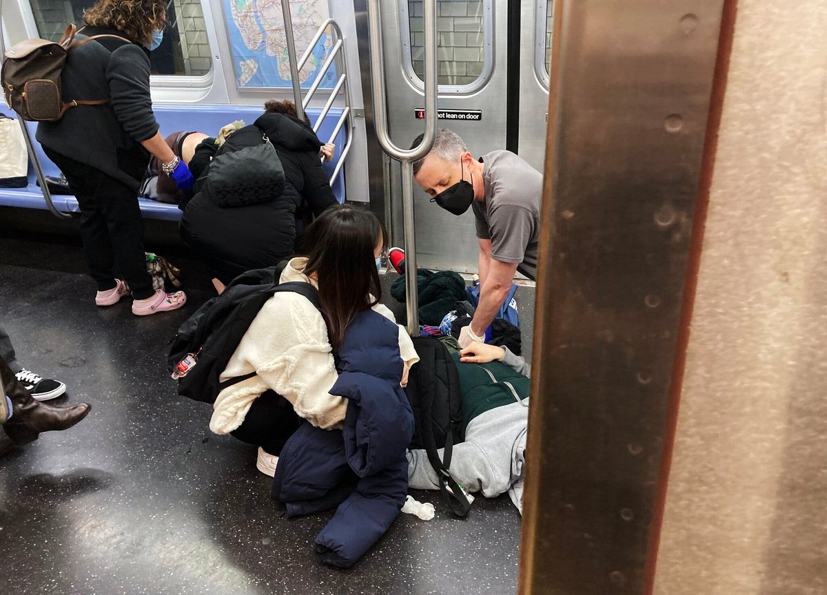 NewsFallon's tweet photo. This photo by @ahinderaker of the @nytimes of ordinary New Yorkers helping ordinary New Yorkers is why I will always love the city of my birth, especially during such a dark, dark day. https://t.co/ktdZbjQFho