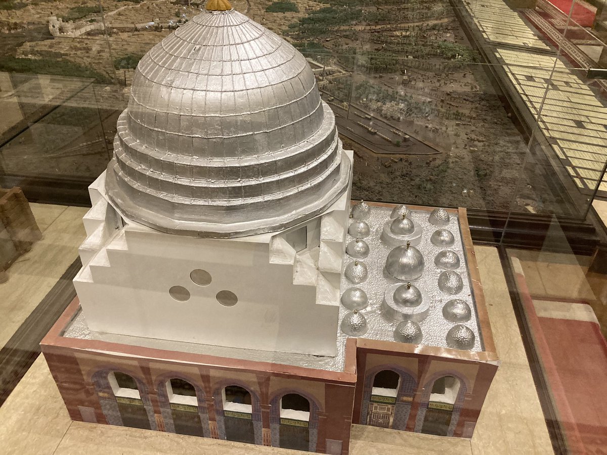 umrah2022's tweet photo. The model in the middle shows us how much the Prophet Muhammad (SAW)’s masjid has expanded over the past 50 years.                          Question: When did the green dome become green? https://t.co/jkKg0hTUih