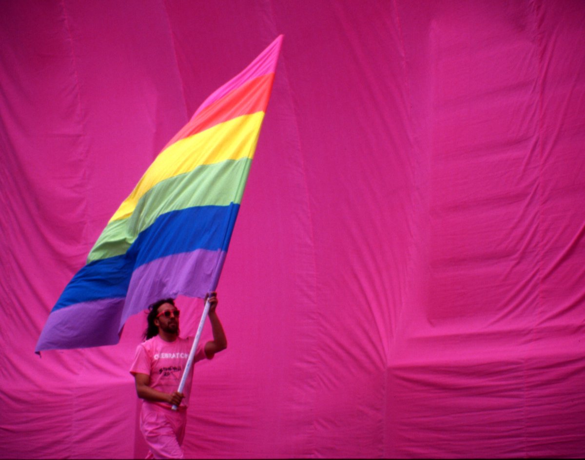 Robert Pruzan - Gilbert Baker waving the Rainbow Flag (1989). 