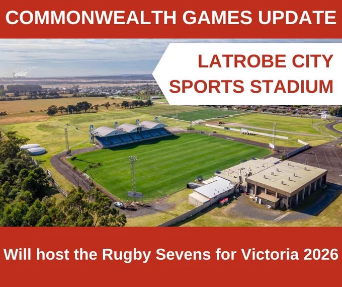 An aerial photo of a sports pitch and grounds, with and white on red text along the top of the image that says “Commonwealth Games Update”, red on white text that reads “Latrobe City Sports Stadium” in the top right hand corner, and white on red text that reads “will host the rugby advents for Victoria 2026”.