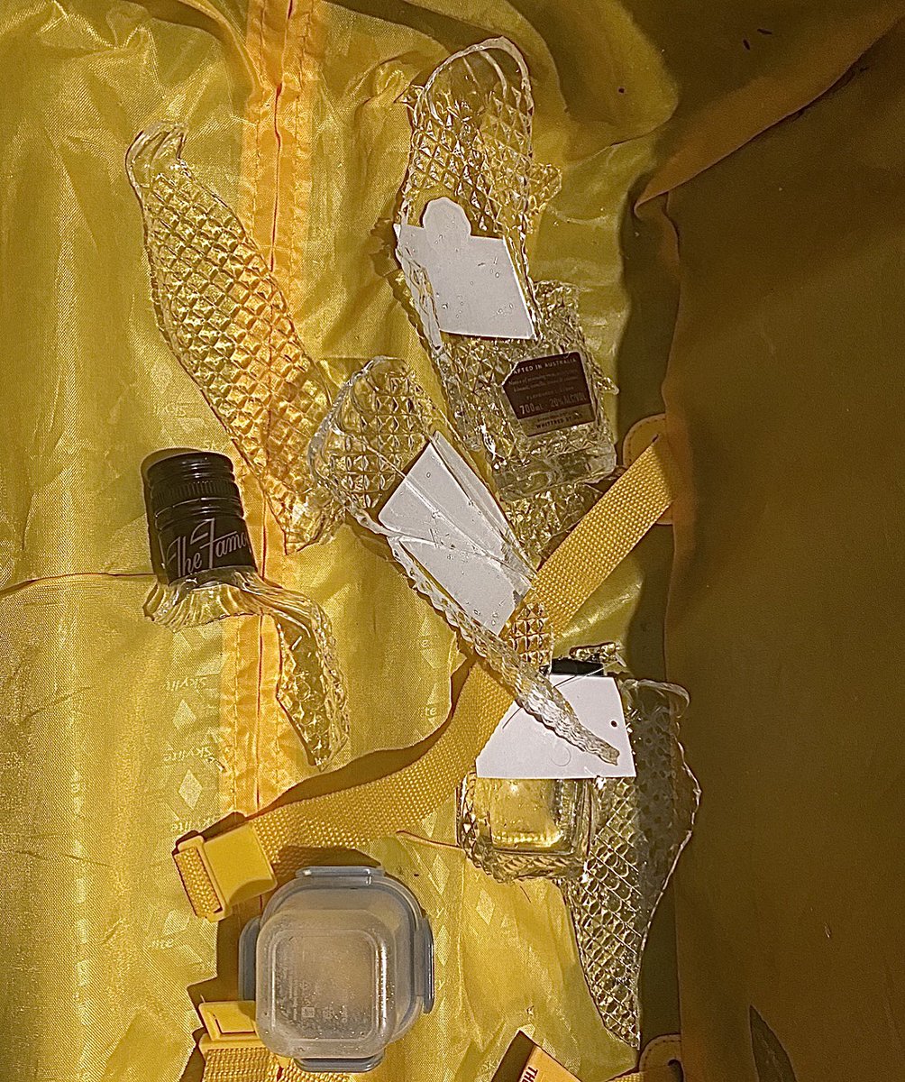 BareCoaching's tweet photo. Hey @Qantas , I have up after waiting on hold for 2.5hrs to try and discuss your baggage handlers care of passengers luggage. It’s like they drop kicked it a few times. This was wrapped up in clothing but completely destroyed @bundabergrum Rum Ball liquer gone 😢 https://t.co/IWvqMxyQEB