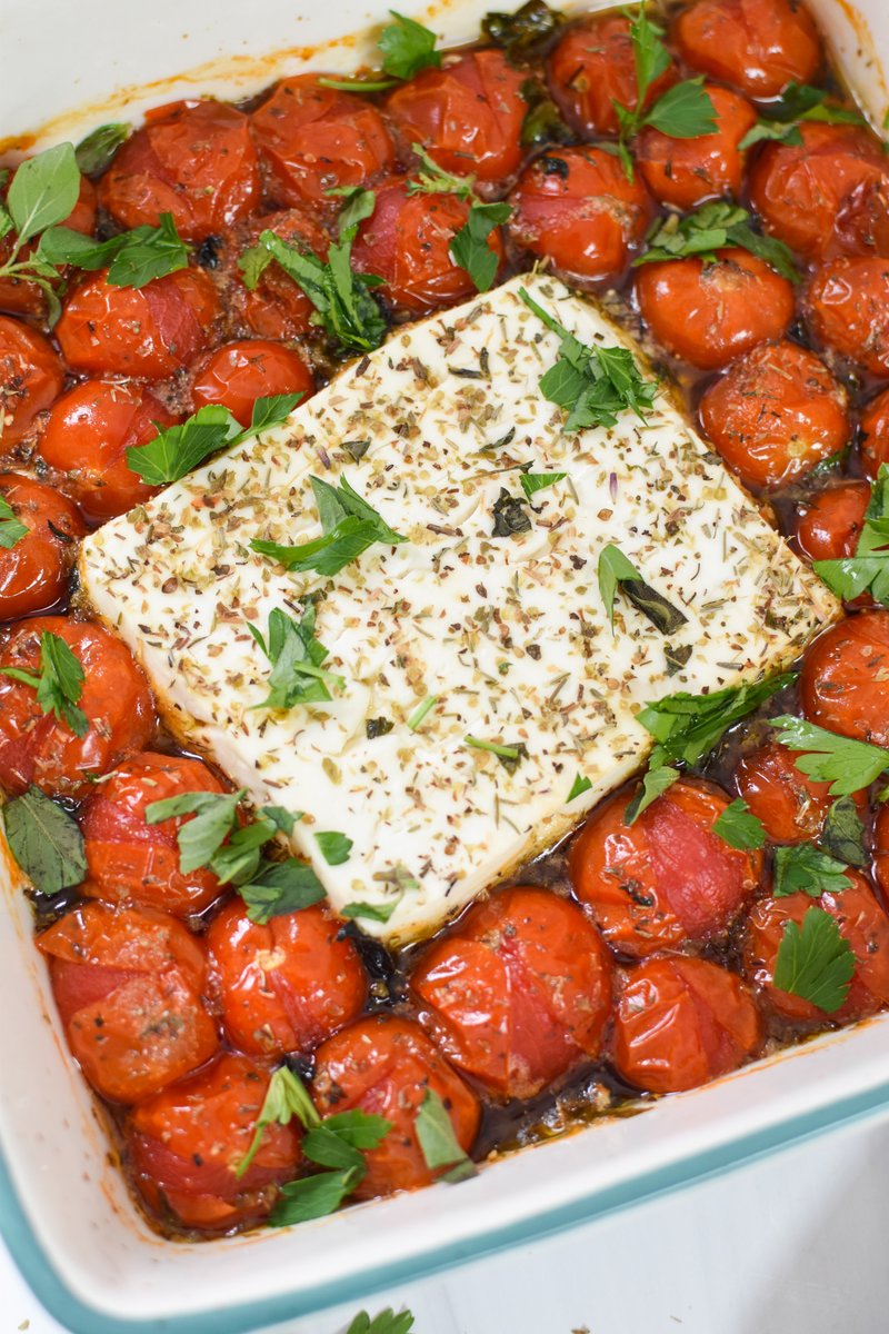 This Easy Baked Feta Recipe is the perfect appetizer for a crowd. A block of feta cheese is baked with cherry tomatoes, olive oil and fresh herbs. You will love the creamy, tangy feta paired with the sweet tomatoes. Serve with crostini! #ad <a href="/adamideast/">ADA Mideast</a> buff.ly/3rprqCT