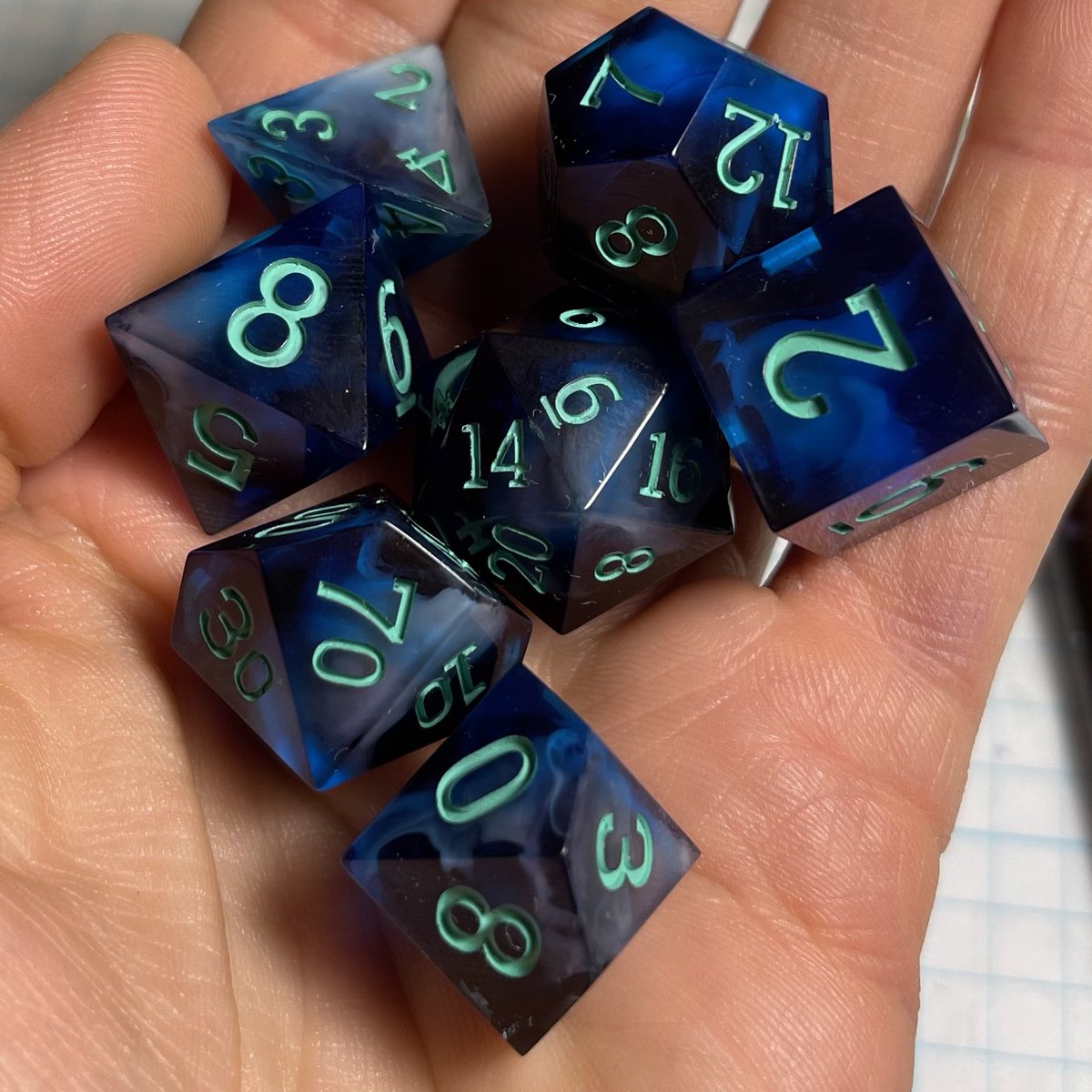 I only occasionally get to do sets like this with swirls hidden inside darker resin, and I had forgotten how much I love this style. 

#Dnd #dice #ttrpg #resinart #handmadedice