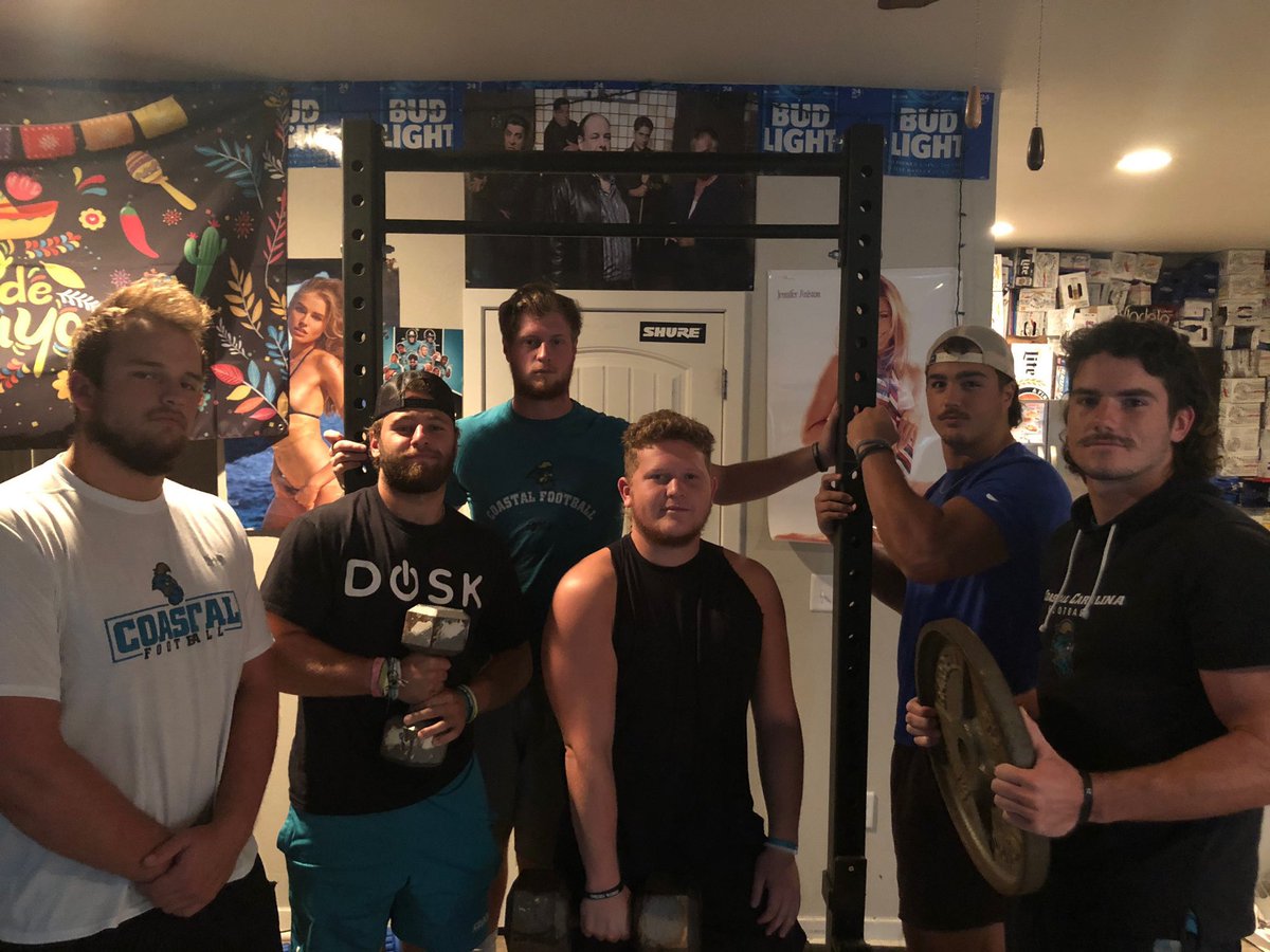 GroupOfFiveGuys's tweet photo. Covid tried to shut @CoastalFootball down. @teddyjgallagher and the fellas said no thanks. Proof that these guys ran the strength and conditioning program out of the living room! 

Check out or interview with him on Apple podcasts https://t.co/yx6e9W2H0F https://t.co/Zo5RUPxJSb
