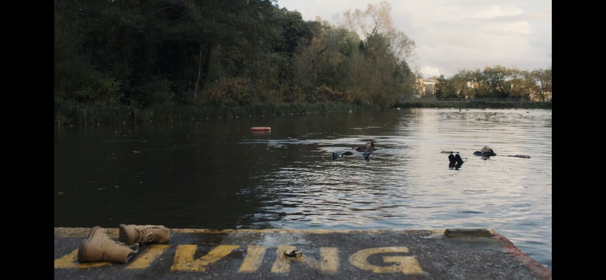 kyxsyn's tweet photo. Easter eggs in scenes with water hinting that #Villanelle is alive: 
- Lars/Johan “drowned”
- Pam &amp; Carolyn floating in the lake while a pair of shoes partially covers the “DIVING” sign turning it into a “LIVING” sign

Everyone aboard the Resurrection Theory 🤡 #KillingEve https://t.co/H98MHxF3jP