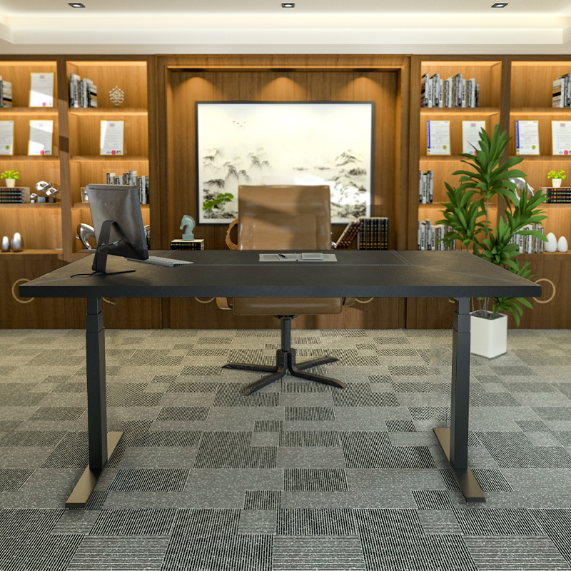 Height adjustable desk in black color.