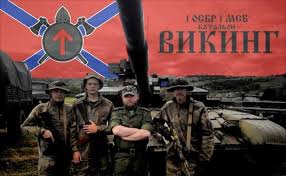 Petrovsky wears a T-shirt with the text "Viking Battalion". The Battalion uses the rune TYR, also used in the past by the 32nd SS Volunteer Grenadier Division "30 Januar" and by neonazis nowadays. (9/24)