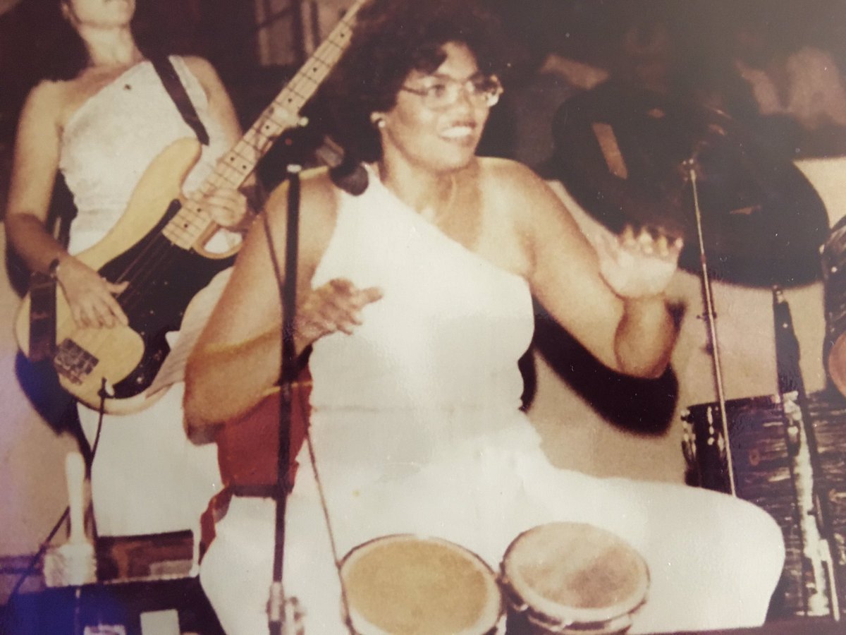 EMannLand's tweet photo. Today is my mothers “Annette Lopez” birthday she would have been 71 years old today. Here is another photo of her doing what she loved, preforming and playing the bongos. Also a clipping from the @villagevoice about her All female band #LatinFever
@Faniamusic @pianojudio https://t.co/DmoKdGHo4m