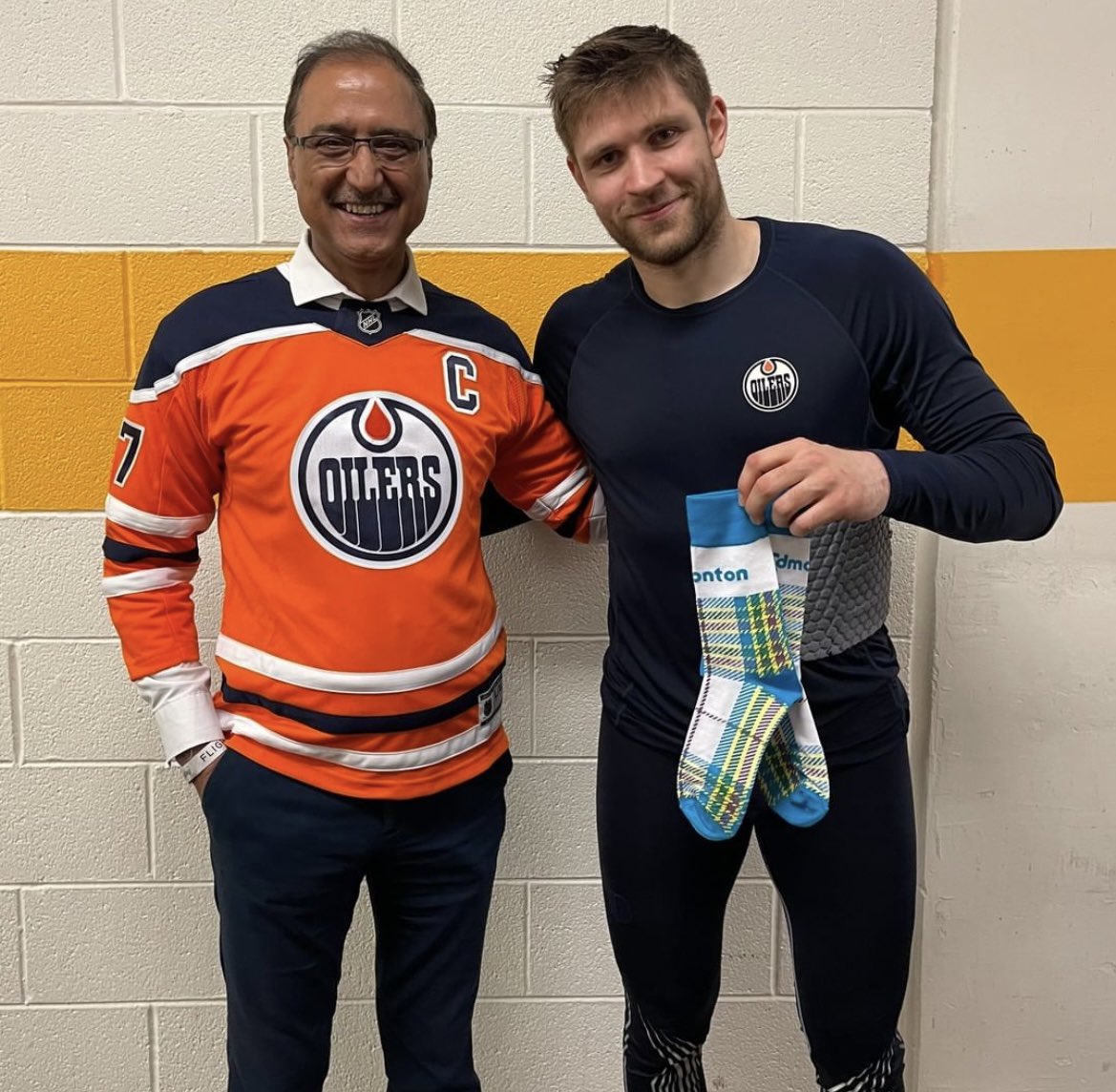 Mayor Sohi with Draisatl, holding a pair of gifted CoE socks