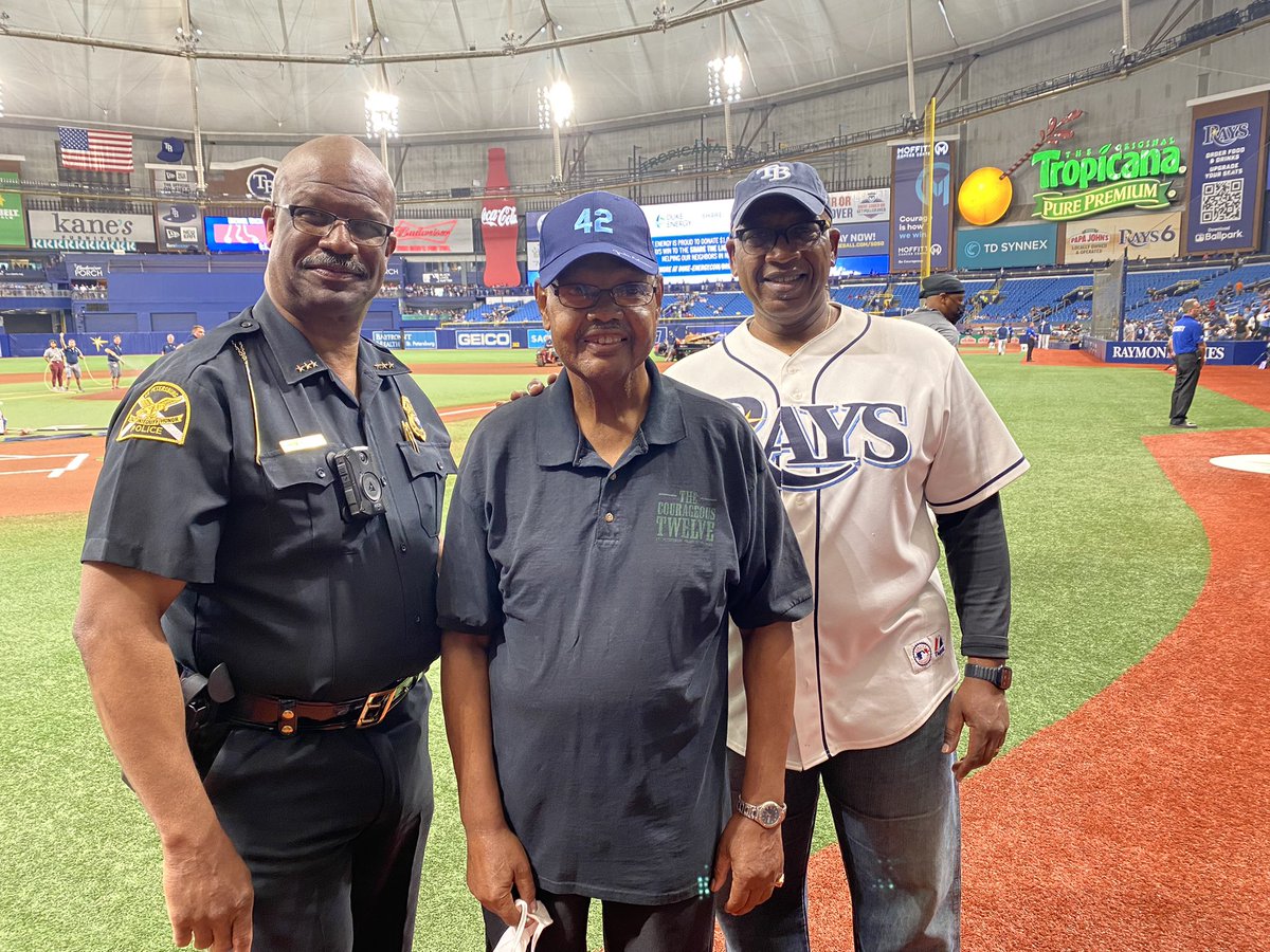 StPetePD's tweet photo. #stpetepd’s Courageous 12 retired Officer Leon Jackson was honored at today’s @RaysBaseball game for his historic role to desegregate the PD. @MayorKenWelch &amp; Chief Holloway joined him for #JackieRobinsonDay . He shares his story w/ teen journalists!👮🏾‍♂️🚓 https://t.co/FZT1Q3kPRf