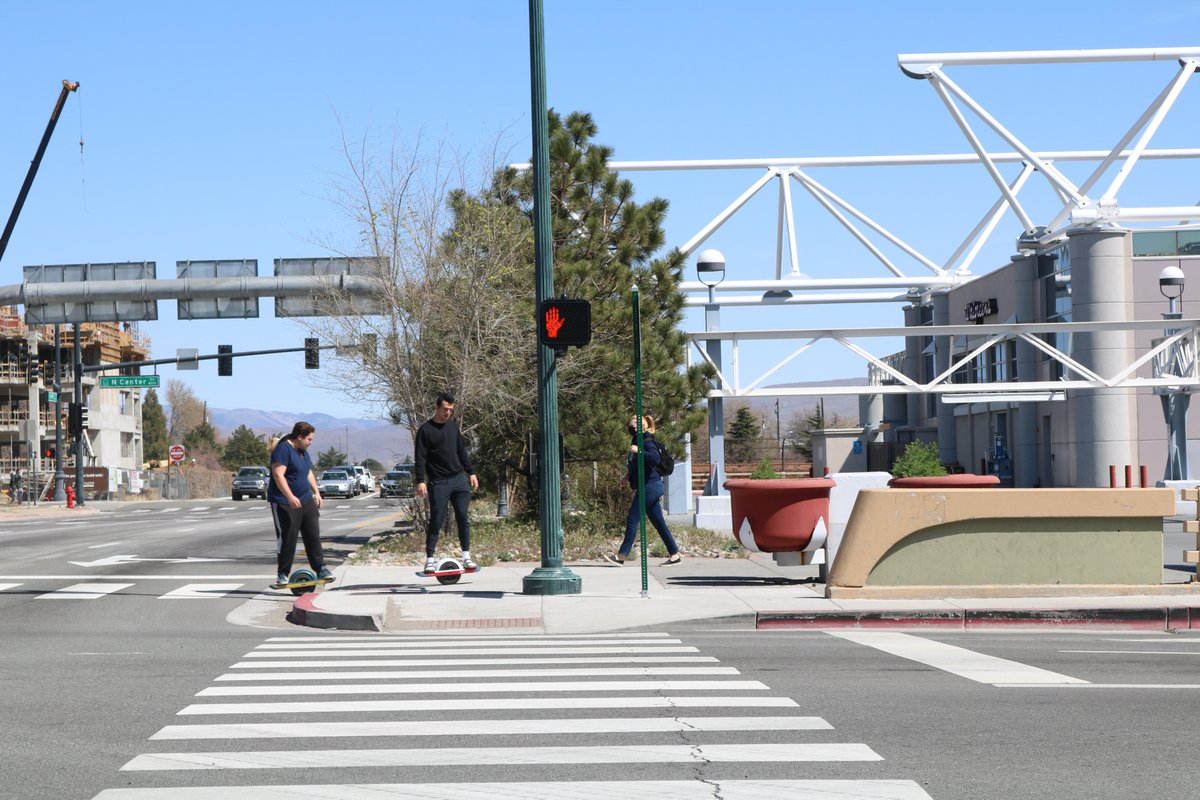 OurTownReno's tweet photo. While there are lingering issues about scooter parking at UNR, Bird scooters are arriving to downtown #Reno soon.  In the meantime these students are enjoying their one wheelers.  We think it would be better if scooters could be used by people for free as part of city's budget https://t.co/S8YVWQ9fOW