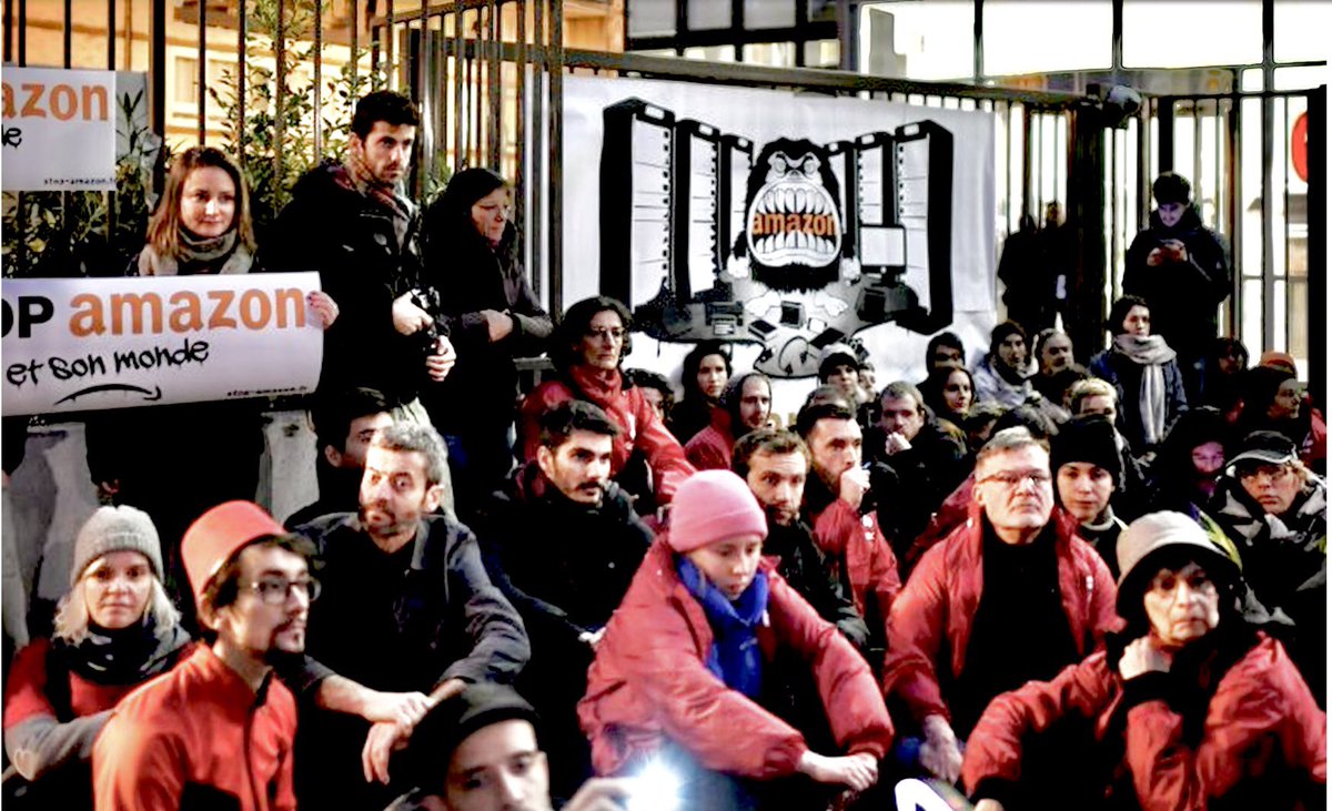 U.S. AUTHOR MARK CRAMER (OLD MAN ON A GREEN BIKE) BICYCLING IN FRANCE asks a postwoman:”Do you have more and more e-commerce packages?” "That's how it is," she replies. “We are not far from the day when we will all be Amazon employees.” Attac members occupying AMZN HQ in Clichy: