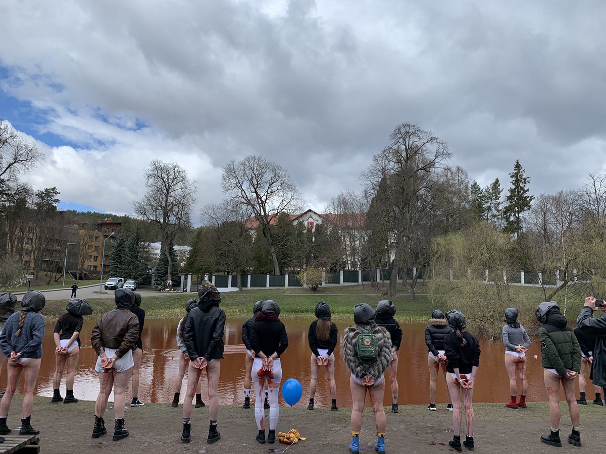 neringark's tweet image. Protest in Vilnius against russian barbarism in front of russian embassy. The pond is still red from our performance "swimming through"