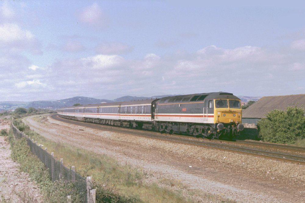 Presenting a very tidy corporate image, Intercity 47527 'Kettering' sweeps through Ryhl with a Euston to Holyhead boat train on 30th May 1989

#Class47 #BrushType4 #InterCity #BririshRailways #NorthWalesCoast