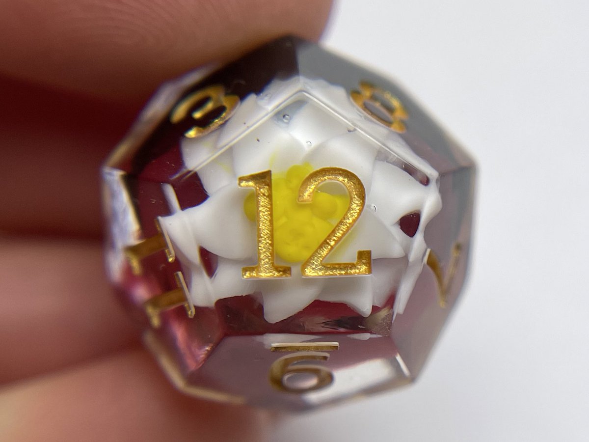 I made little edelweiss flowers out of resin for these inserts. My mom used to sing that song to me all the time as a child, so I was very happy to take on this commission. 

#Dnd #dice #ttrpg #resinart #handmadedice #Edelweiss