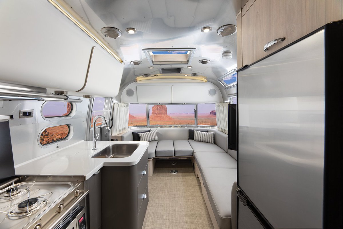 The Globetrotter exemplifies modern design with spacious seating and a luxurious kitchen. Make an escape to your sleek home on wheels after a day of outdoor adventure. ✨ Learn more: go.airstream.com/2YIGCN3