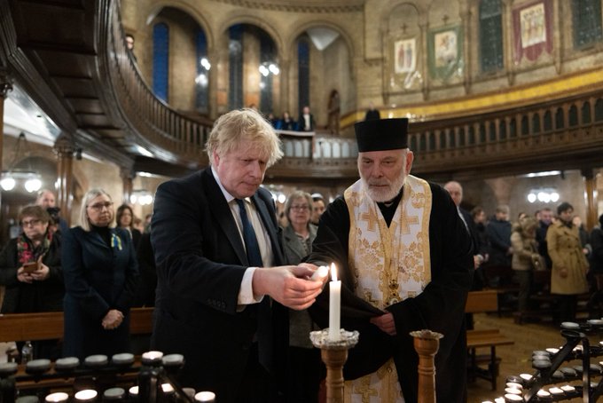 Prume Minister Boris Johnson lighting candle in Ukrainian Cathedral