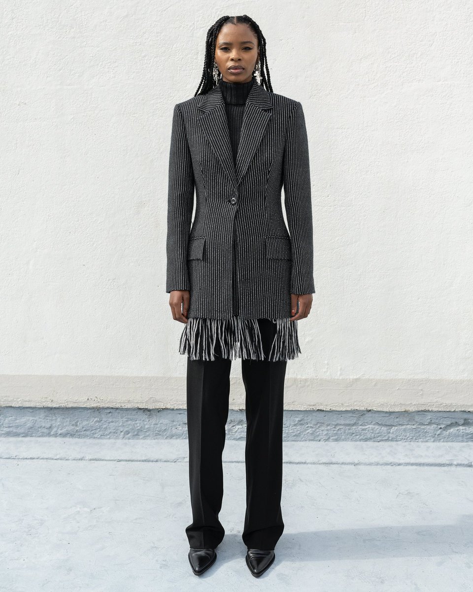 UKHOLO - FAITH AW22’ 

Look 5 - Handwoven Merino Wool Gamp Tailored Jacket, Fringe mini skirt, Wool knitted turtleneck and Black  tailored pants 

PH - @tatendachidora 
Model - @iam_conniemore 
MU - @bassie_makeupartist