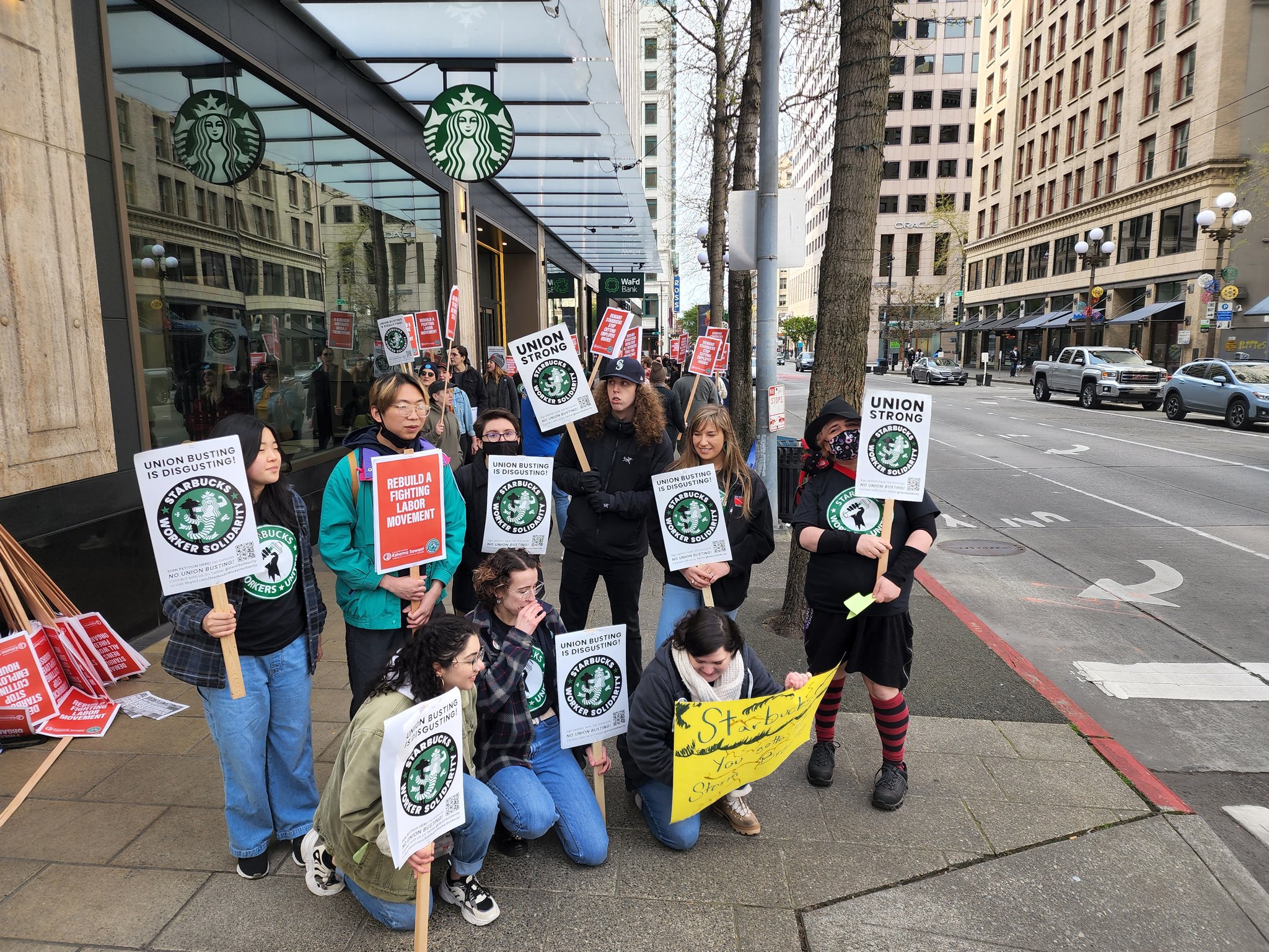 Starbucks workers on strike posing for a photo with Starbucks Solidarity pickets!