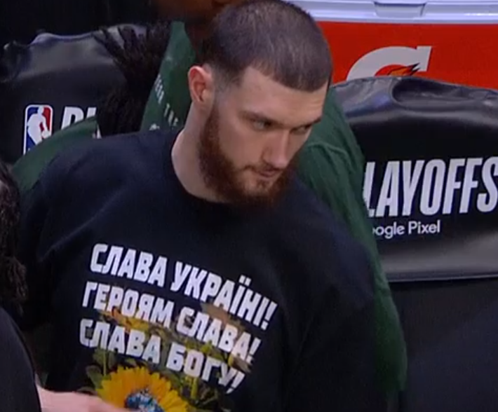 Deleuzer42's tweet photo. Can't tell which looks more fascist Sandro Mamukelashvili or the shirt he's wearing. The American equivalent of this shirt would be something like, "God bless White America!" I wonder if his teammates know he's a neo-Nazi. https://t.co/qLC83akqOy