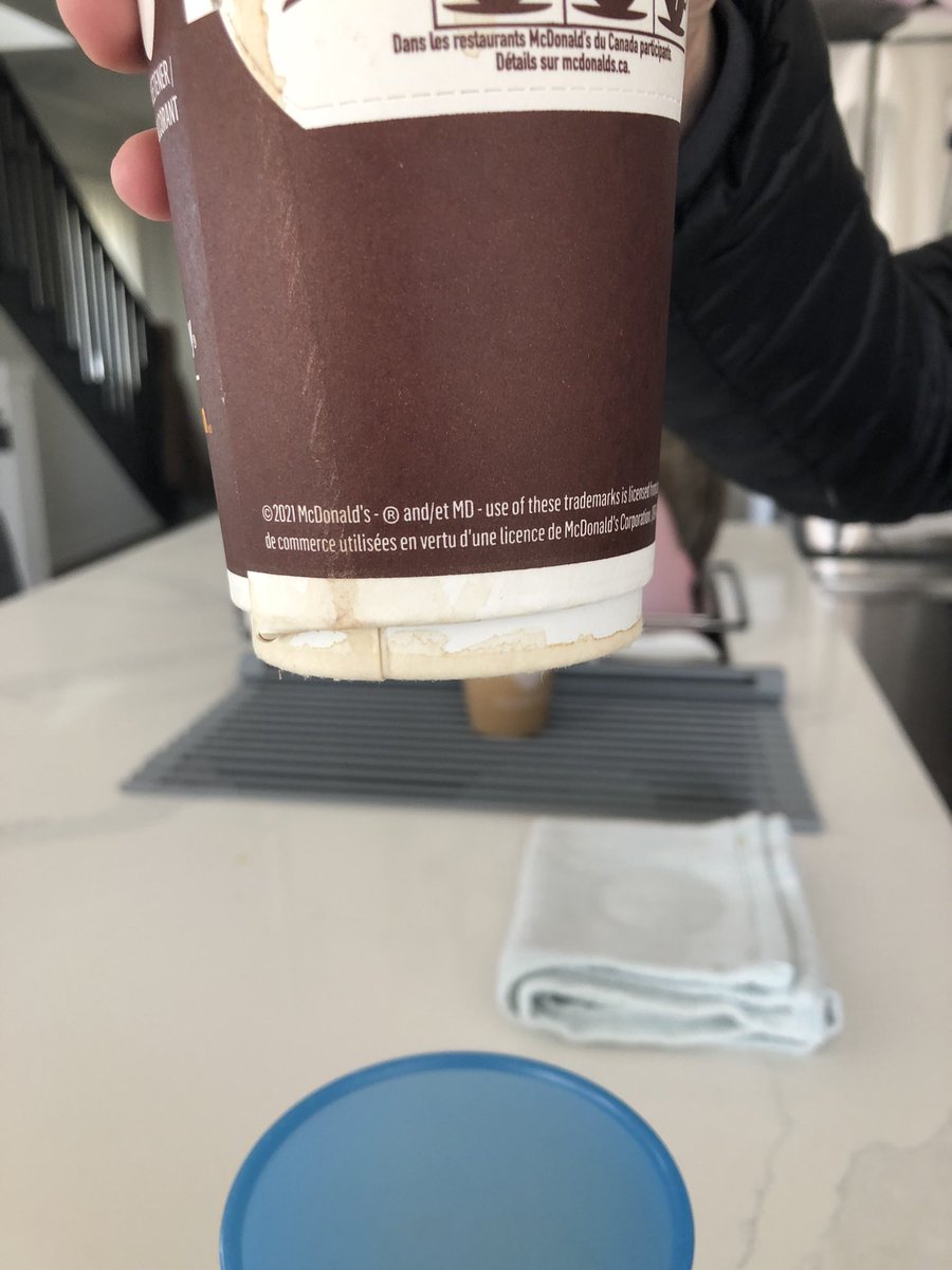 MaustonA's tweet photo. @McDonaldsCanada my coffee today. so many cups just leaking like this, happens weekly 🤔 what’s the deal? have to throw these out. Leaks straight out of the cup all over my clothes and car https://t.co/LCn05qCm4i