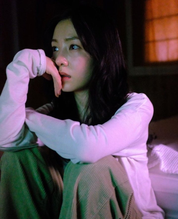 Basking under the faint glow coming from the tinted lights.