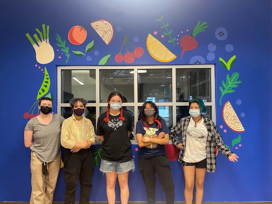 AustinISDFood's tweet photo. We have a beautiful new addition to our office at the @AISDwarehouse! Big thanks to @mslaneart and her @AustinCrockett students for painting this amazing mural for us.  We provided the blank slate, and the students created this fruit and veggie masterpiece🎨🍎🥬🍊 #AISDProud https://t.co/J4rXsmDTYm